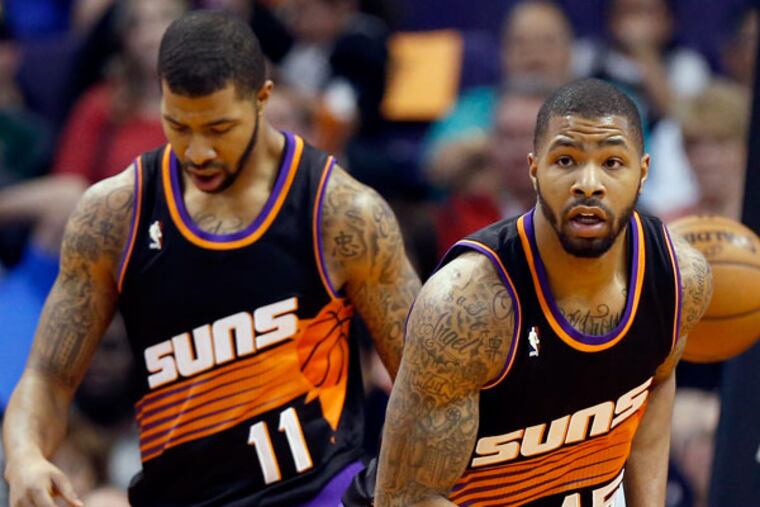 Phoenix Suns' Markieff Morris (11) and his twin brother, Marcus Morris (15) run upcourt during the second half of an NBA basketball game against the San Antonio Spurs, Sunday, Feb. 24, 2013, in Phoenix. (Matt York/AP file photo)