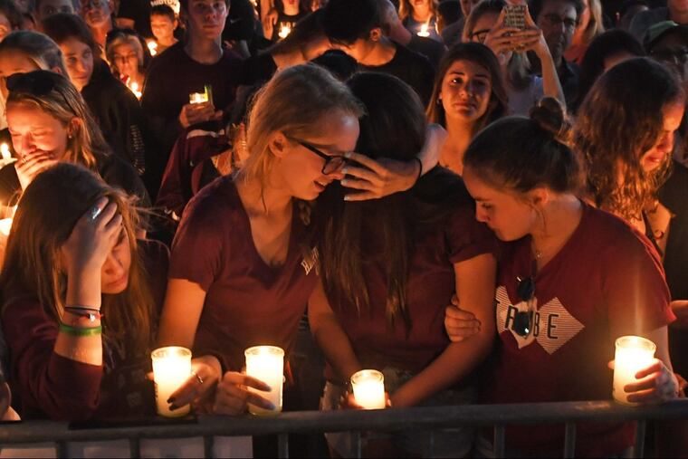 Mourners gather at a vigil for victims of the mass shooting at Marjory Stoneman Douglas High School in Parkland, Fla., on Thursday, Feb. 15, 2018. (Jim Rassol/Sun Sentinel/TNS)