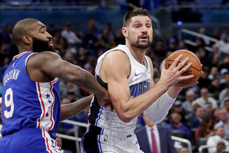 Orlando Magic's Nikola Vucevic, right, scored 12 of his game-high 25 points in the fourth quarter.