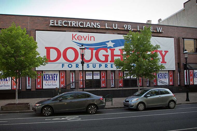 The International Brotherhood of Electrical Workers hung this sign supporting union boss Johnny Doc's brother outside their hall, but city officials say it's way too big.