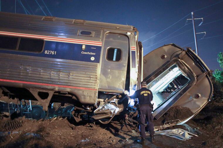 Emergency crews at the May derailment in Philadelphia. Experts have said positive train control would have prevented the disaster. Railroads want more time. JOSEPH KACZMAREK / File Photo
