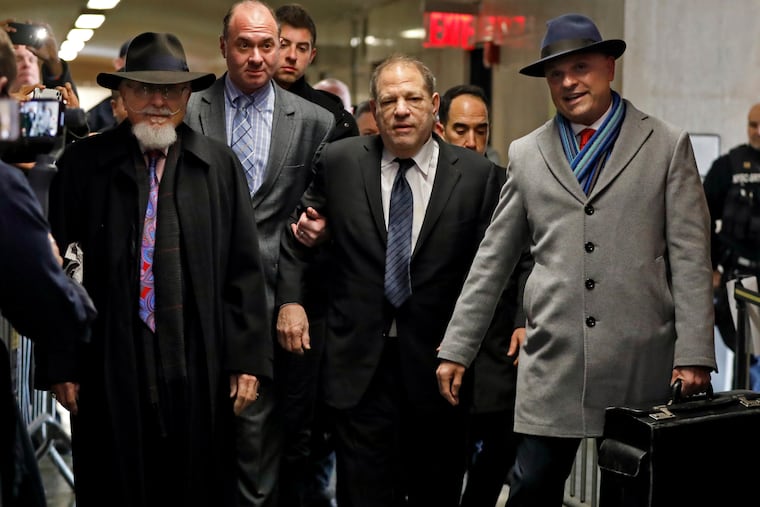 Harvey Weinstein, center, accompanied by attorney Arthur Aidala, right, arrives at court for his rape trial, in New York, Wednesday, Jan. 22, 2020.
