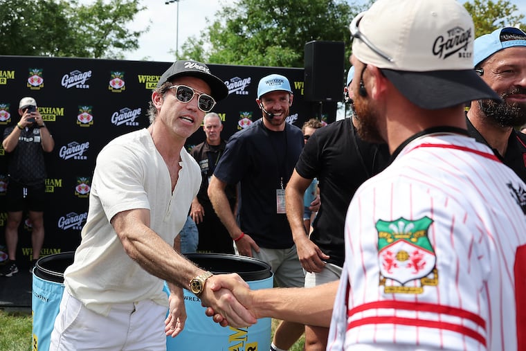 Actor Rob Mac greets Eagles kicker Jake Elliott (right) after playing “Pongadelphia” before the Wrexham and Sunderland match at Subaru Park on Sunday.