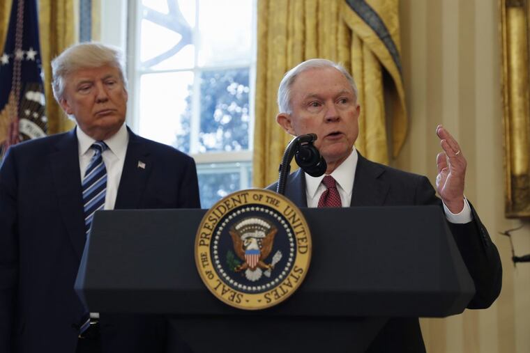 President Donald Trump listens as Attorney General Jeff Sessions speaks in the Oval Office after being sworn into office in February.