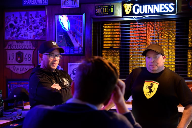 Twin McCusker brothers/bartenders/owners Doug (left) and Ryan (right) at their shift change, when Ryan replaces Doug behind the bar for the night at McCusker's tavern in South Philadelphia.