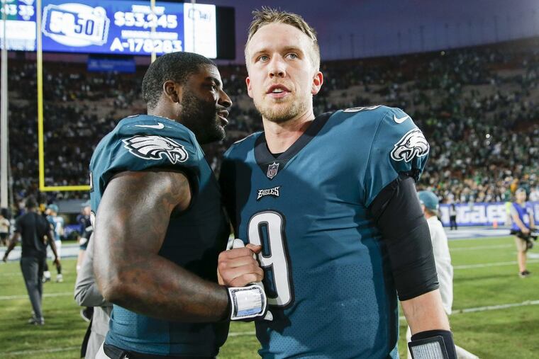 Eagles quarterback Nick Foles with teammate defensive end Vinny Curry after the Eagles beat the Los Angeles Rams on Sunday, December 10, 2017. YONG KIM / Staff Photographer