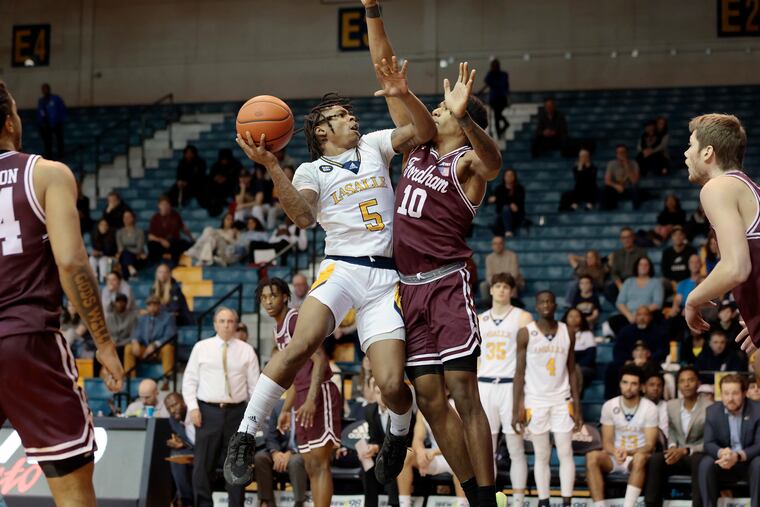 La Salle’s Khalil Brantley shoots over Fordham’s Kyle Rose in the second half between the two teams on Saturday at Tom Gola Arena. La Salle fell to the Rams in a close one, 66-64.