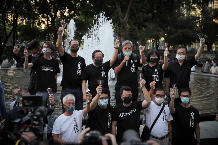 Activists chant slogans during a gathering to mourn those killed in the 1989 Tiananmen crackdown at Victoria Park in Causeway Bay, Hong Kong on Thursday.