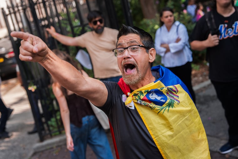 A Venezuelan man, who is in opposition to former Venezuela President Nicolas Maduro and his wife Cilia Flores, shouts at pro-Maduro protesters Wednesday outside Manhattan federal court.