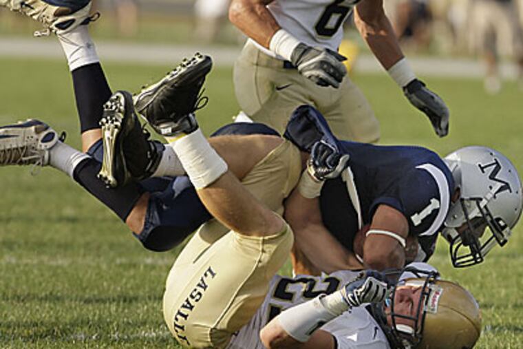 Malvern Prep's Neil Willis, top, steamrolls over La Salle defender Kevin Farrington, falling just short of a touchdown on Friday. (Ron Cortes/Inquirer)