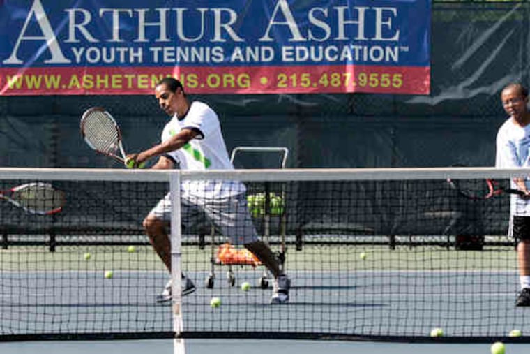 Lance Lee, 31, of the Arthur Ashe Youth Tennis and Education center, demonstrates techniques he learned as an 8-year-old participant in the National Junior Tennis League.