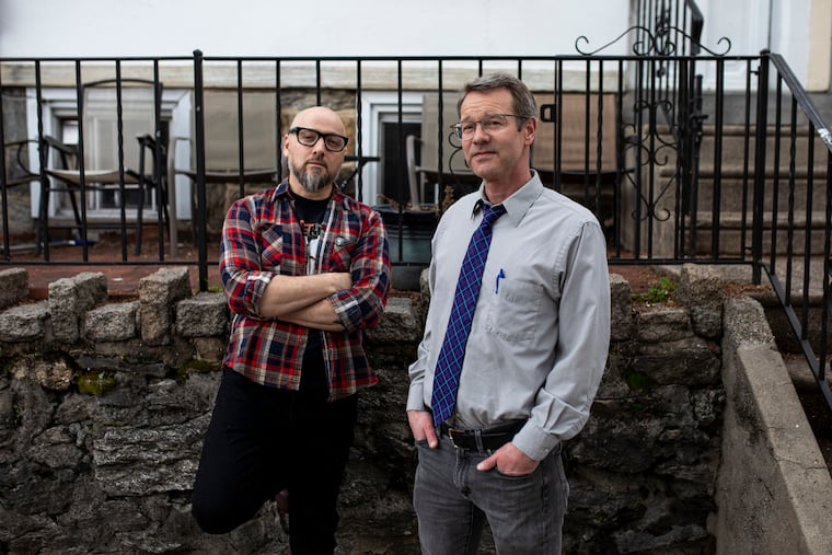 Janis Chakars, 50, of Roxborough, a professor at Neumann University and organizer for the record, (right), and Derik Moore, 47, pose for a portrait in Philadelphia, Pa., on Friday, March 25, 2022. They gathered seven Ukrainian bands and nine American bands to create the Band Together album to benefit Ukraine.