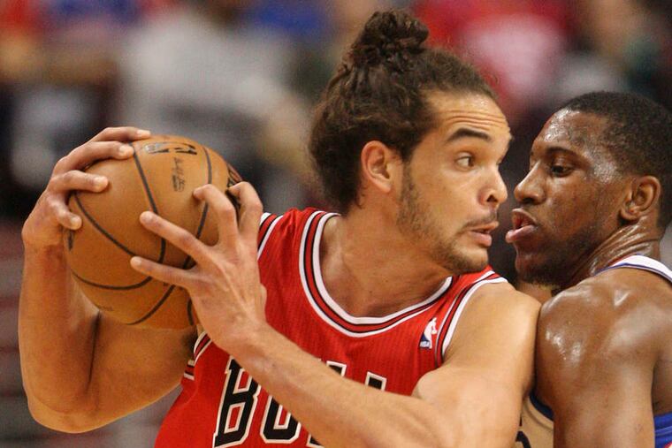 Chicago's Joakim Noah, guarded by Thaddeus Young, finished with 21 points and seven rebounds against the Sixers. Young had 13 points and nine rebounds for the home team. STEVEN M. FALK/ Staff Photographer