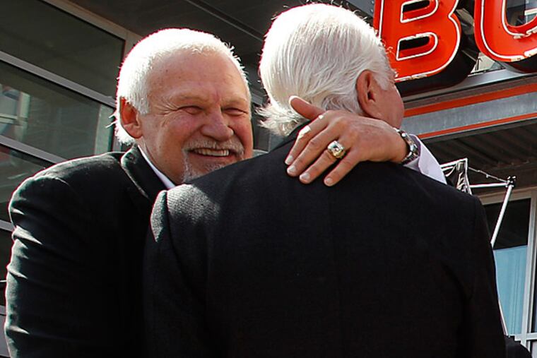 Bernie Parent (left) hugs Flyers chairman Ed Snider.