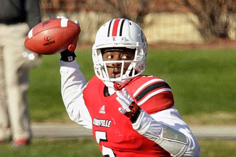 Louisville quarterback Teddy Bridgewater throws a pass during their NCAA college football game against Connecticut in Louisville, Ky., Saturday, Nov. 24, 2012. Louisville will leave the Big East to go to the ACC in 2014. (Garry Jones/AP)
