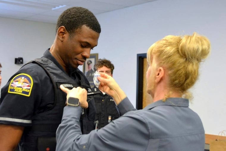 In this undated photo provided by Old Orchard Beach Police Department, Officer Jon Luke Evans receives his police badge. Assistant Secretary of Homeland Security Tricia McLaughlin accused the town of “reckless reliance” on the E-Verify program when it hired the Jamaica national.