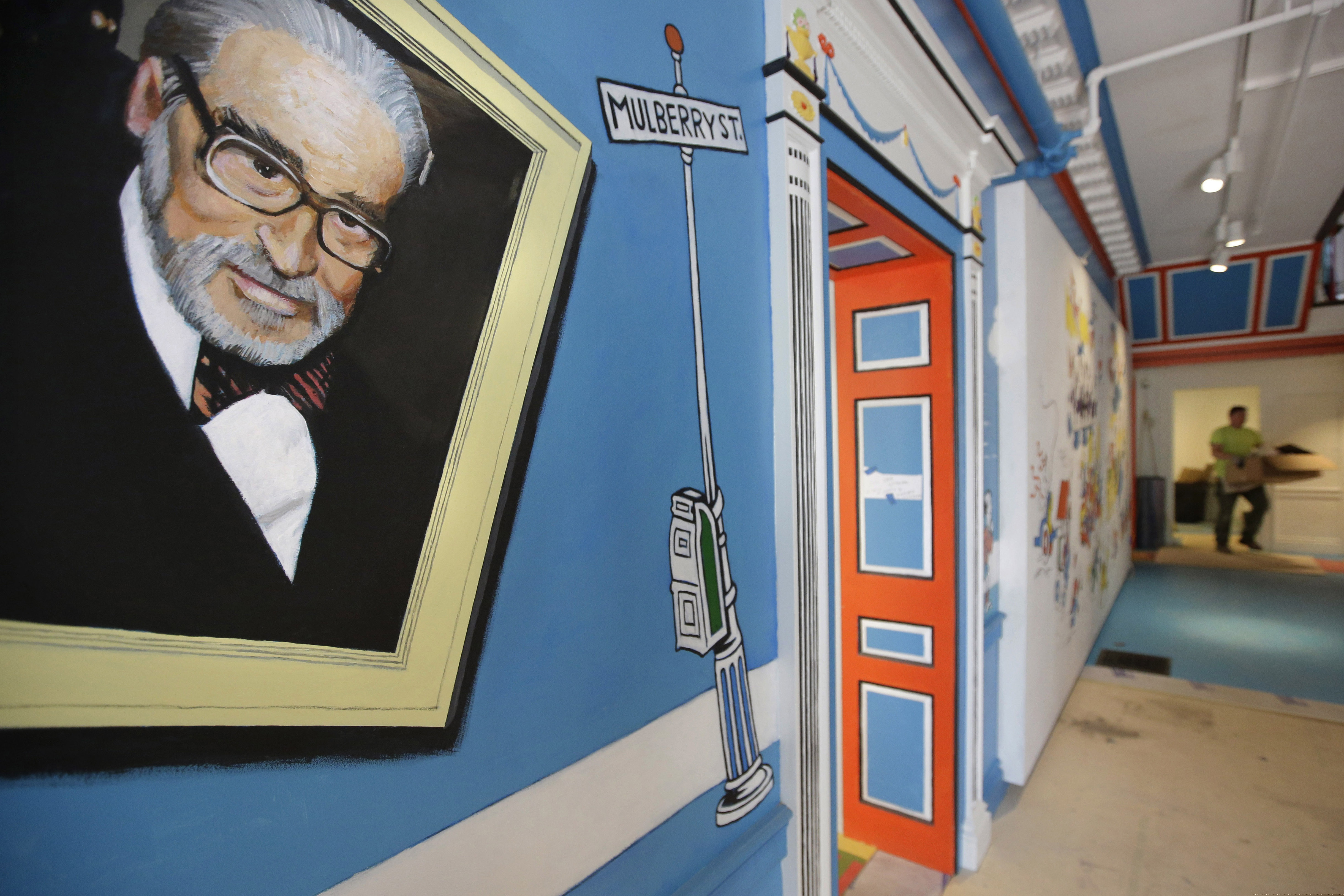 A mural that features Theodor Seuss Geisel, left, also known by his pen name Dr. Seuss, covers part of a wall near an entrance at The Amazing World of Dr. Seuss Museum, May 4, 2017, in Springfield, Mass. Sketches of fantastic creatures by Dr. Seuss that have never before been published will see the light of day in new books being written and illustrated by an inclusive group of up-and-coming authors and artists, the company that owns the intellectual property rights to Dr. Seuss' works announced Wednesday, March 2, 2022.