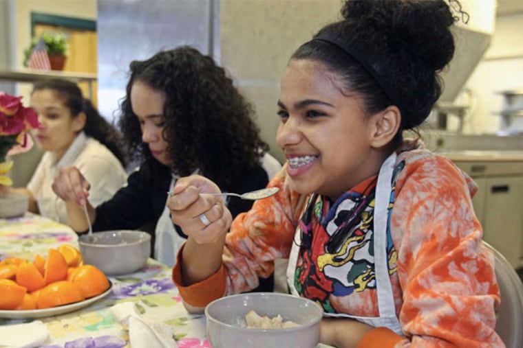 Brittany Jordan, 15 (right), samples her cereal.