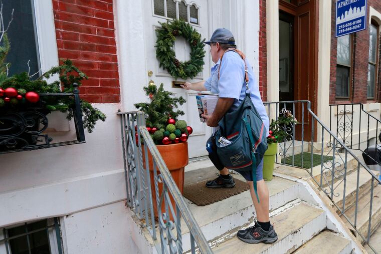 Vince Young delivers mail along 26th Street on Christmas Eve 2018.