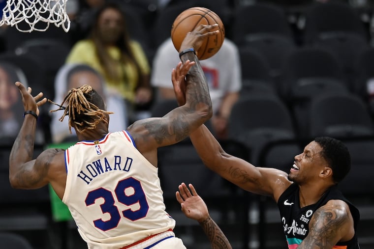 Dwight Howard is fouled as he attempts to shoot against the Spurs' Rudy Gay.