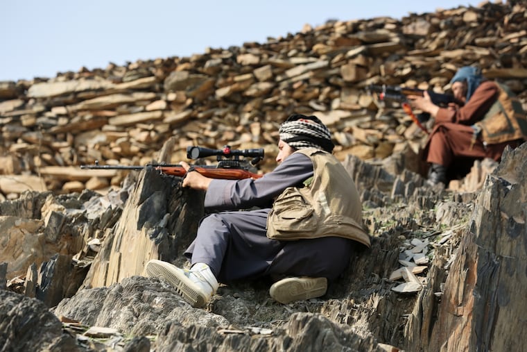 Afghan Taliban soldiers peer through the sight of their weapons, on the Afghan side of the Torkham border crossing with Pakistan in Torkham, Afghanistan, on Friday.