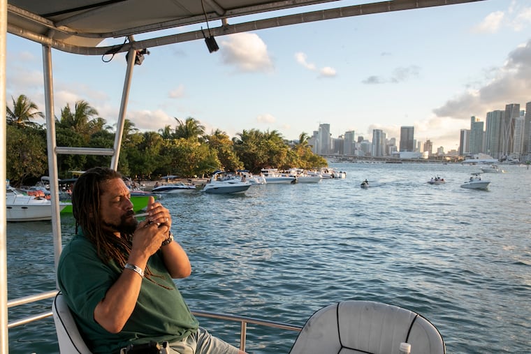 File photo of Ed Forchion, known as the NJWeedman, smoking while relaxing on his boat with friends and family in front of downtown Miami on Saturday, Feb. 26, 2022.