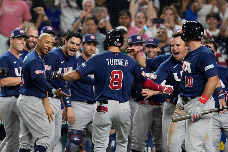 U.S.'s Trea Turner (8) is congratulated by the team after hitting a home run against Japan.