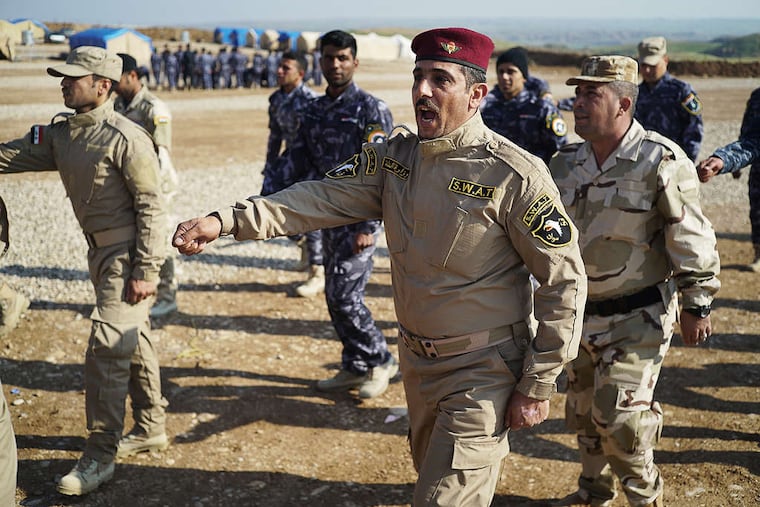 Police officers perform drills at Nineveh Liberation Camp in Dubardan, Iraq. The camp is home to hundreds of police officers who fled Mosul in June and now are training to retake the city. AYMAN OGHANNA / Washington Post
