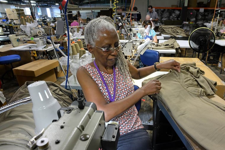Blind worker Arlene Still of Lawnside sews a military uniform at Bestwork Industries in Cherry Hill. “I’m grateful to have a job,” she said. “I love it.”