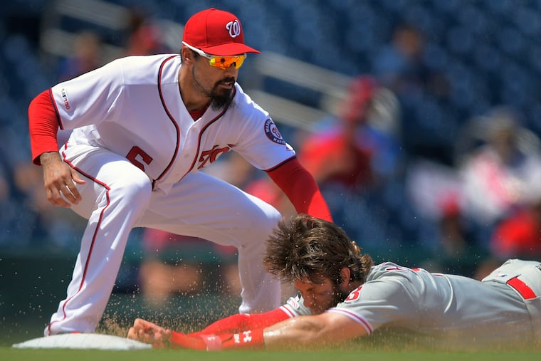 Nationals third baseman Anthony Rendon tags out the Phillies' Bryce Harper in the sixth inning of Game 1. Harper was trying to go from first to third on a single, but center fielder Gerardo Parra threw him out.
