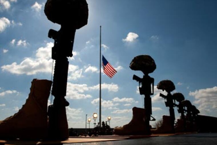 A flag flies at half-staff on Tuesday at Fort Hood, Texas, during a memorial service for the shooting victims. (AP Photo/Jay Janner)