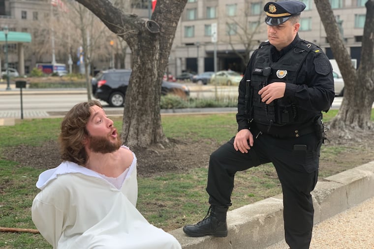 MIchael Grant, popularly known around Philadelphia as "Philly Jesus," is cited with trespassing after being escorted out of the Cathedral Basilica of Saints Peter and Paul during the installation of new Archbishop Nelson Perez.