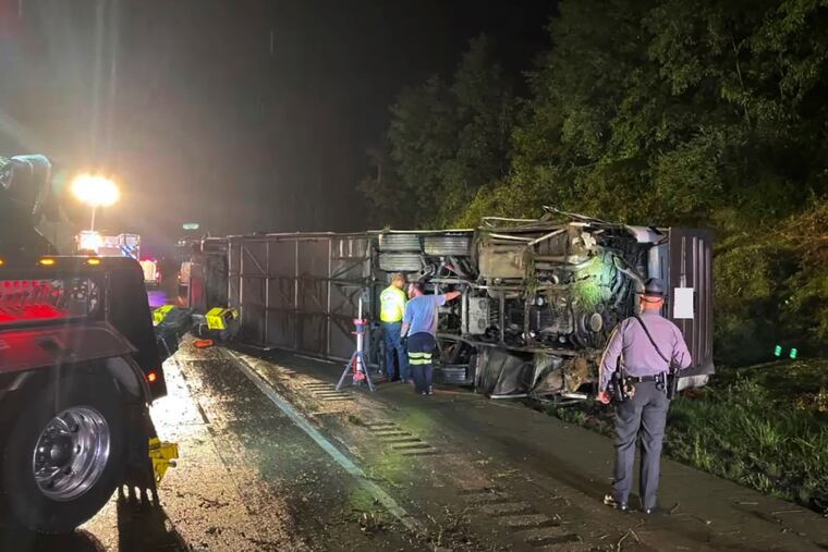Police and rescue workers arrive on the scene of a bus crash in Lower Paxton Township, Dauphin County, Pa.