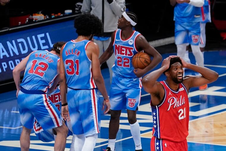 Joel Embiid (21) reacts to a foul called on him during the second half of an NBA basketball game against the Brooklyn Nets.