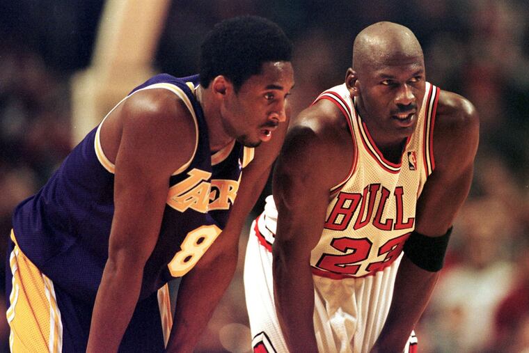 Los Angeles Lakers guard Kobe Bryant, left, and Chicago Bulls guard Michael Jordan talk during a free-throw attempt on Dec. 17, 1997 at the United Center in Chicago.