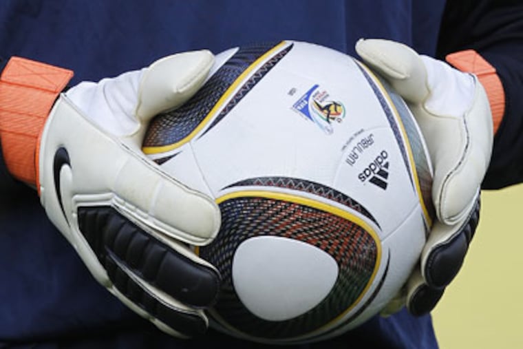 U.S. goalie Marcus Hahnemann grips the Jabulani ball. "It's terrible, horrible," said Brazil's Julio Cesar. (AP / Elise Amendola)