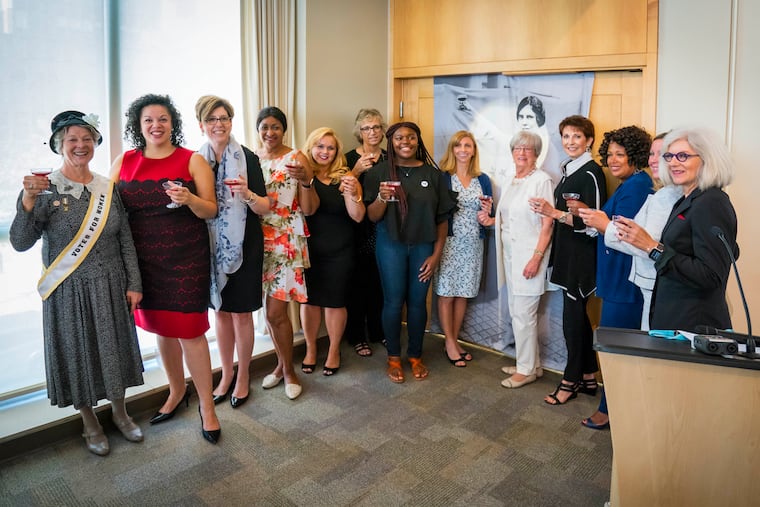 Participants of Drexel University's Vision 2020 women's equality program take their annual Toast to Tenacity for Women’s Equality Day in 2018. They are raising glasses of grape juice to toast women’s progress, as suffragist Alice Paul did in 1920 when the 19th Amendment to the U.S. Constitution was passed.