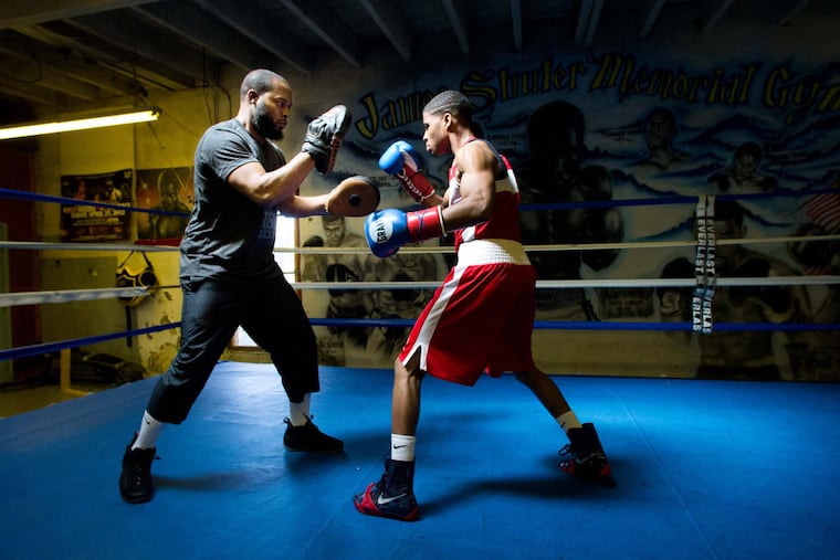 Stephen Fulton Jr. (right) working out in the ring with trainer Hamza Muhammad in April 2013.