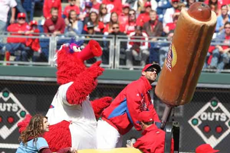 Phillies pitcher Cliff Lee fires hot dogs into the stands during the Phillies exhibition game with the Toronto Blue Jays on March 30, 2013. ( CHARLES FOX / Staff Photographer )