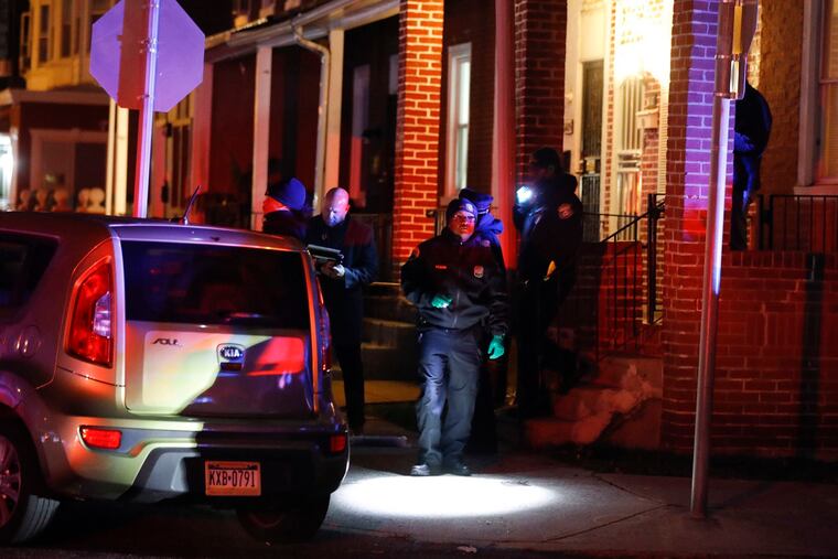 Investigators at the scene of a November shooting in Crescentville. As of Tuesday, the city had recorded 530 homicides.