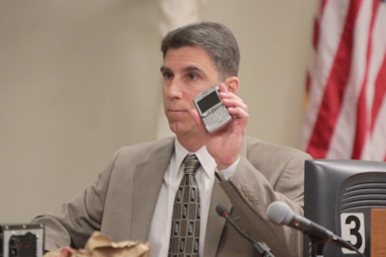Investigator Robert Torrisi presents Dharun Ravi's BlackBerry during the trial. Some of Ravi’s text messages were read to the Superior Court jury. (JOHN O'BOYLE / Star-Ledger, Pool)