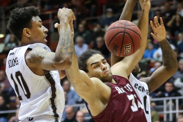 Jaylen Adams, left, colliding with St. Joseph's Javon Baumann, is the Bonnies’ leading scorer.