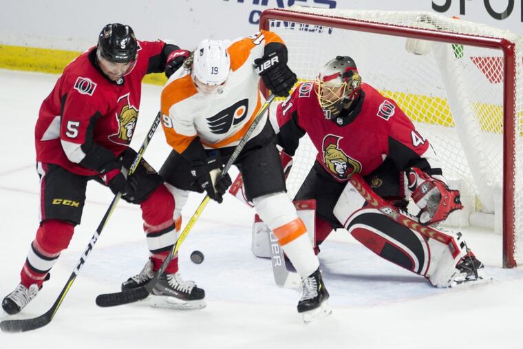 Flyers center Nolan Patrick tries to deflect a shot under pressure from Ottawa defenseman Cody Ceci during the Flyers’ 5-3 win.