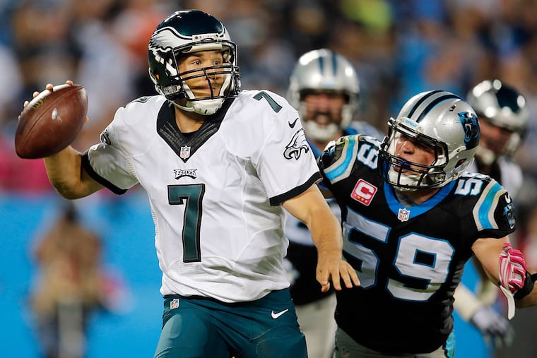 Sam Bradford scrambles past the Panthers' Luke Kuechly.