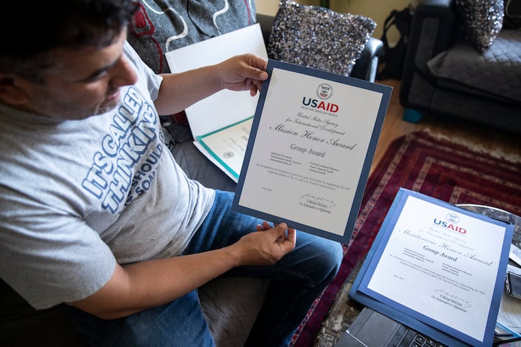 Sadiq Sadeed shows some of the awards he received from USAID, the development agency, at his home in the Mayfair section of Philadelphia. He was translator at USAID in the U.S. Embassy in Kabul, Afghanistan.