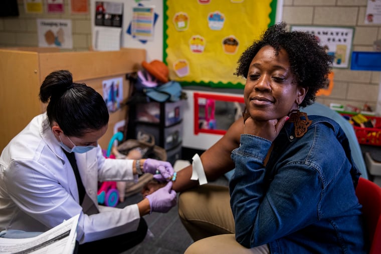 Somerset Academy, at 719 W. Girard Ave. in Philadelphia, is among the companies that use Vitable LLC to provide primary and urgent care to their employees. Here, Tiffany Chavous, Somerset's director, is getting her annual physical as well as her blood drawn for TB testing by Vicky Tubens-Lowa, a Vitable nurse practitioner.