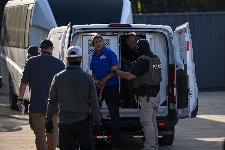 People in custody of Immigration and Customs Enforcement agents arrive at an ICE facility in Franklin Park, Illinois, in September.