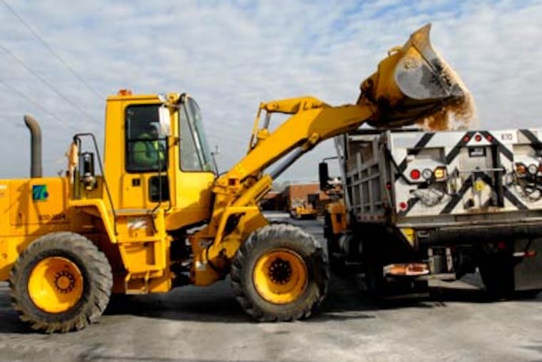 At a PennDOT facility in North Philadelphia, workers load road salt into a truck as part of preparations for a storm expected to start dropping snow across the region by tomorrow morning. (April Saul / Staff Photographer)