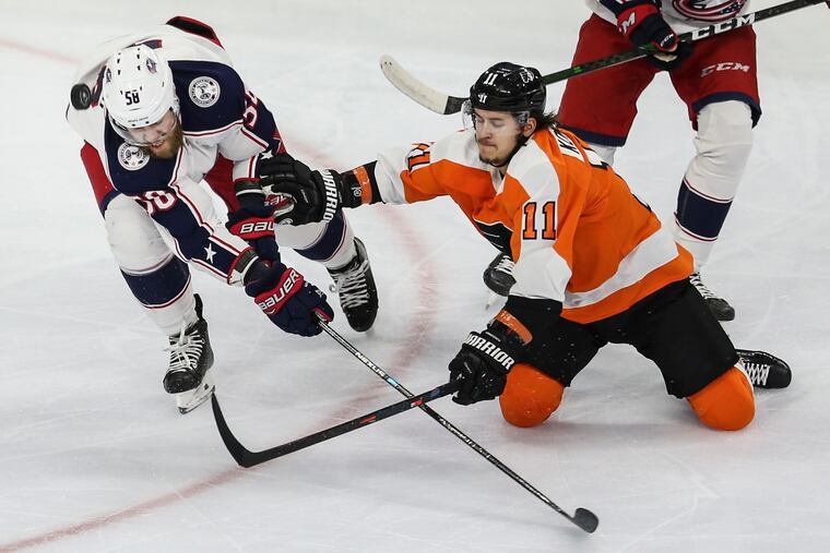Flyers right winger Travis Konecny (right) battling for the puck Tuesday with Columbus' David Savard. Konecny had three points in the Flyers' 5-1 win.