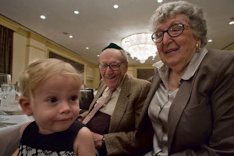 At right, Kaylee Alford, 1, takes it all in , to the amusement of Albert, 92, and Catherine Freeman, 89, at the seder. At left, Sultana, 24, and David Sady, 26, in their 1916 wedding photo. Their family along with the Avayou family founded Congregation Shaareh Zion in Atlantic City four years later.